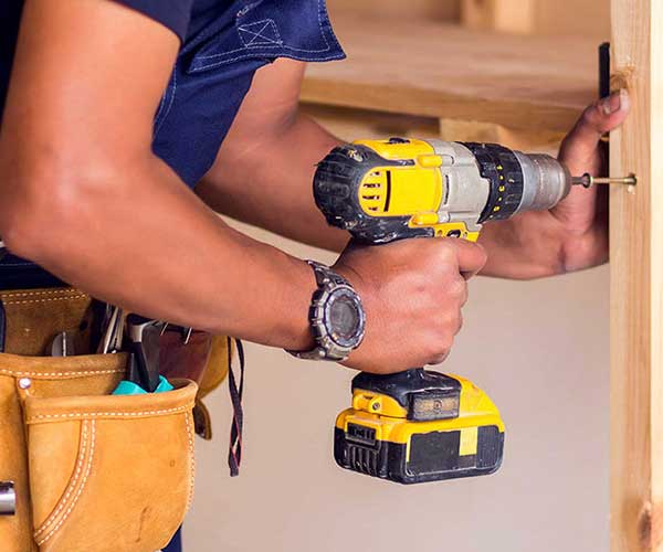 Software for handyman being used on site with man using power drill