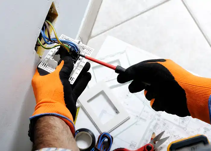 Electrician wiring a residential outlet