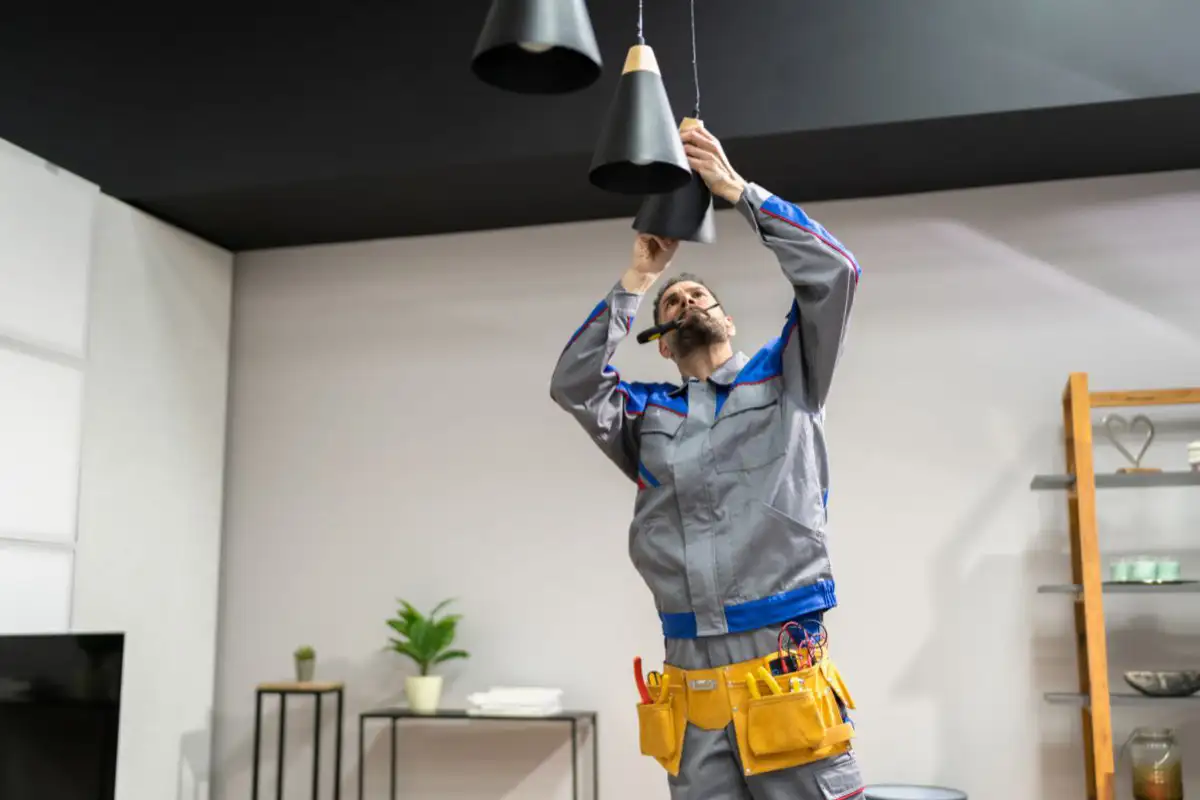 Maintenance Tech Fixing Light